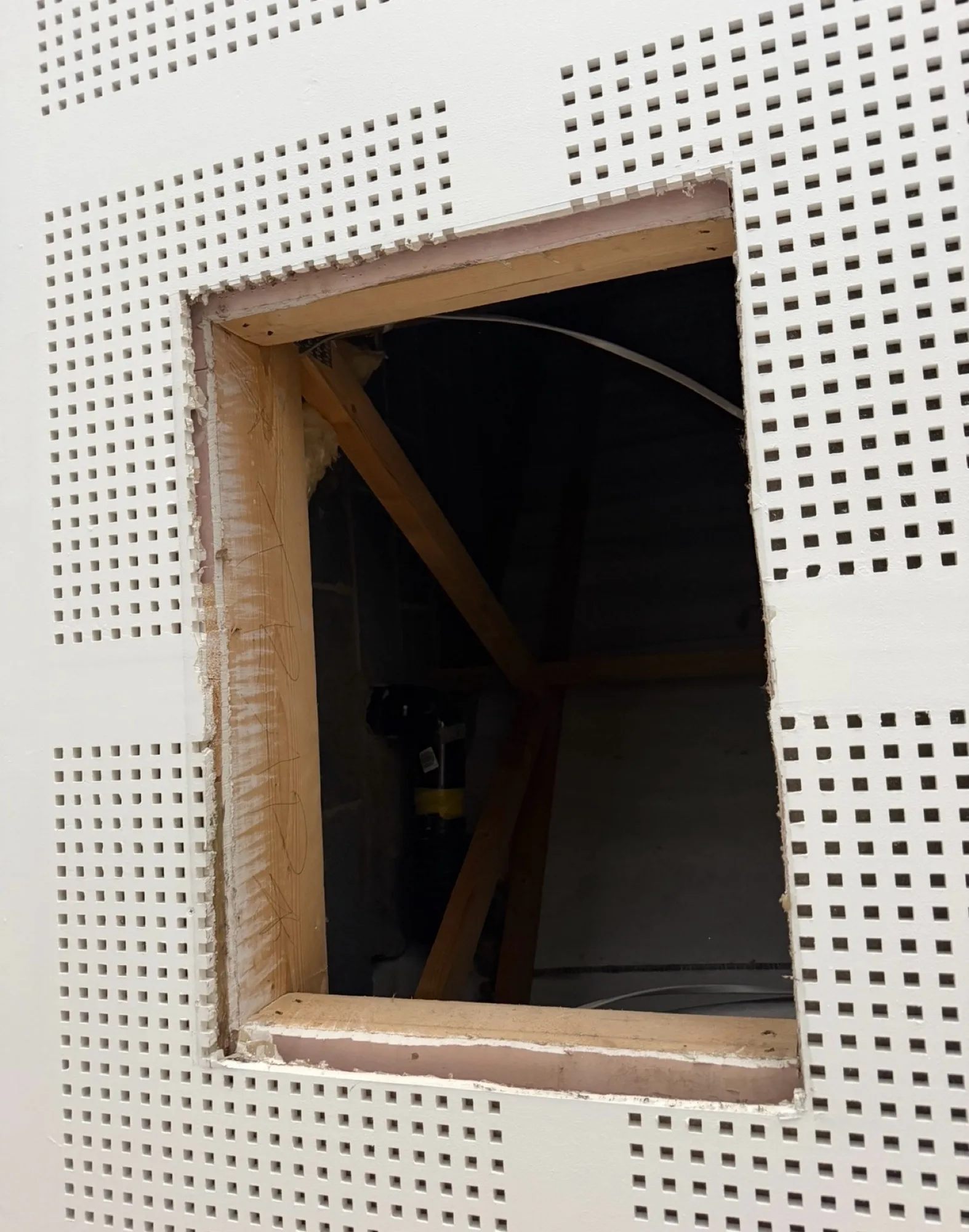 Open wall section showing framing for access panel installation