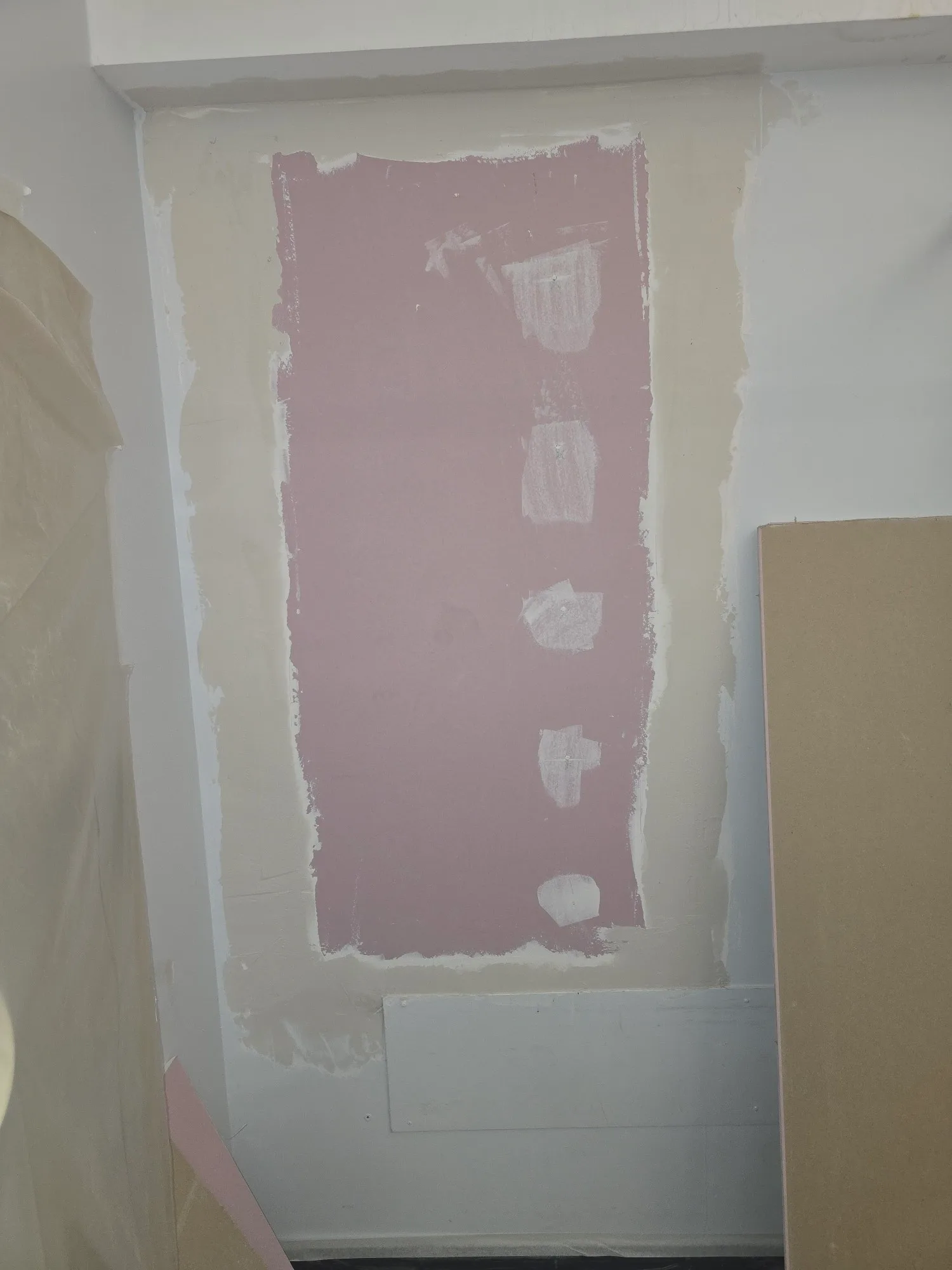 Fire stopping installation process with patched wall showing preparation for fire barrier application