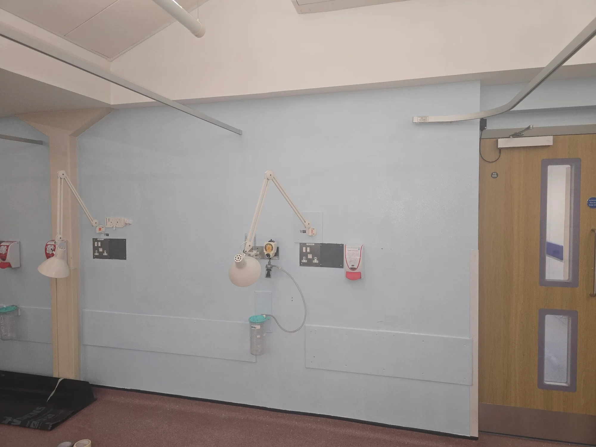 A well-lit room featuring fire protection equipment mounted on the wall