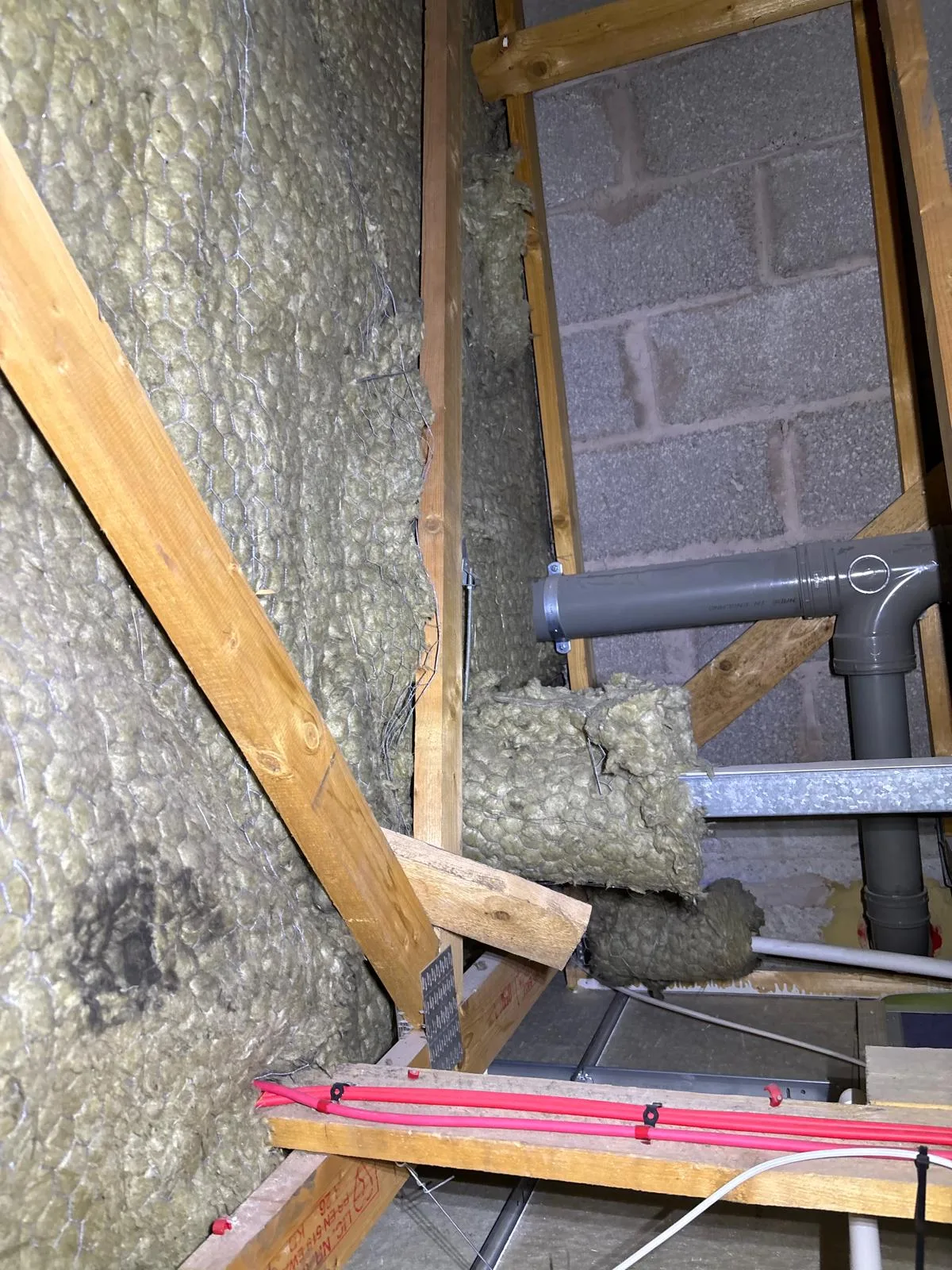 Insulation material and pipes in an attic space, relevant for Fire Compartmentation Works