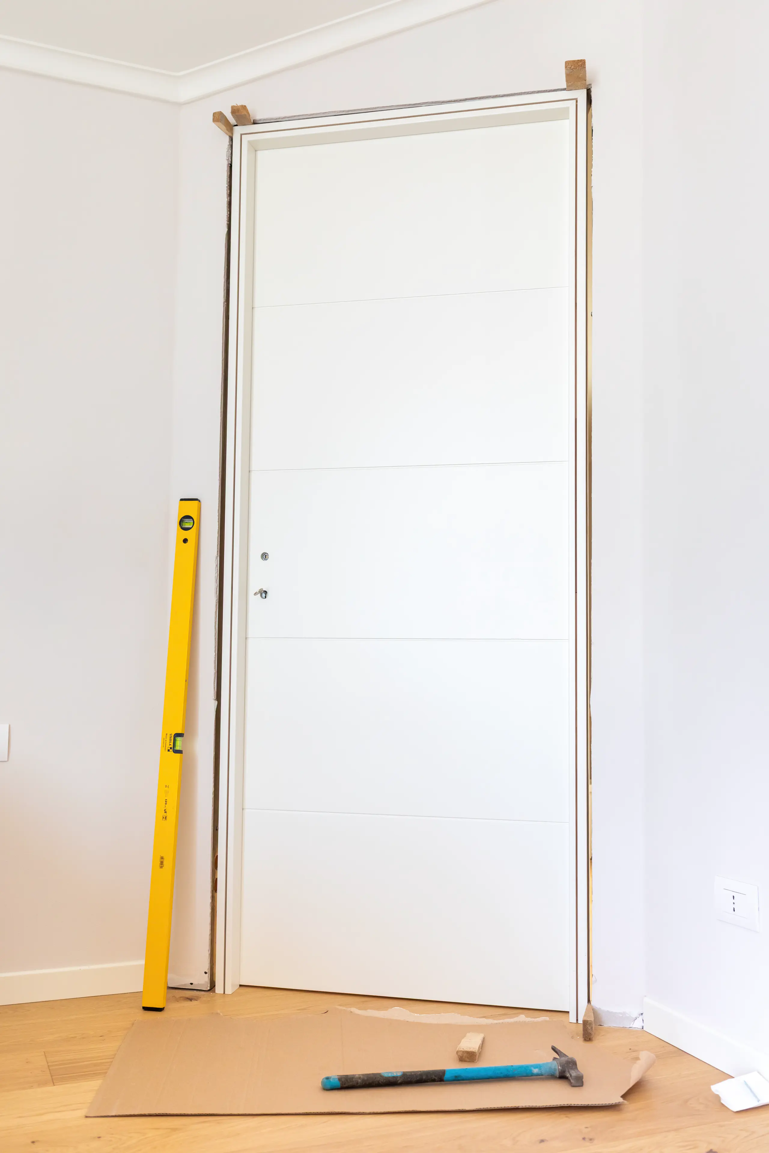 Installation of a fire door with tools and a level nearby
